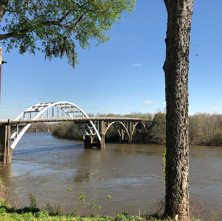 landscape view of river and Edmund Pettus Bridge