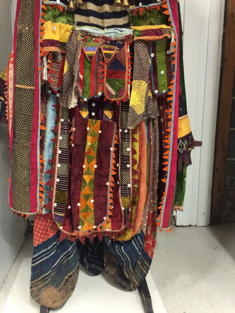 Oyo-Yoruba Egungun ensemble, 20 th century. Hand-woven and machine spurn textiles embellished with cowrie shells, aluminum, string, thread embroidery, leather, pitch, brass, plastic buttons and plastic sequins. Photo: Bolaji Campbell